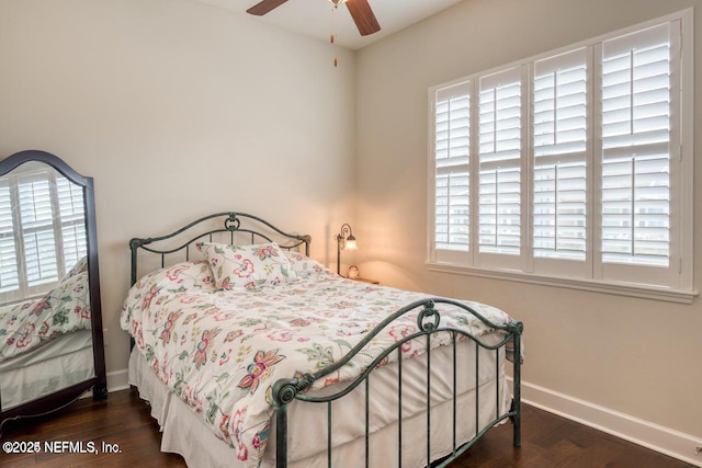 bedroom with dark hardwood / wood-style floors and ceiling fan