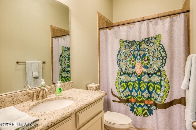 bathroom featuring vanity and toilet