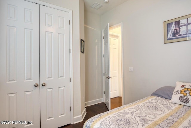 bedroom featuring dark hardwood / wood-style floors and a closet