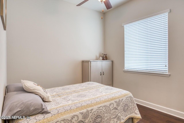 bedroom with dark hardwood / wood-style floors and ceiling fan