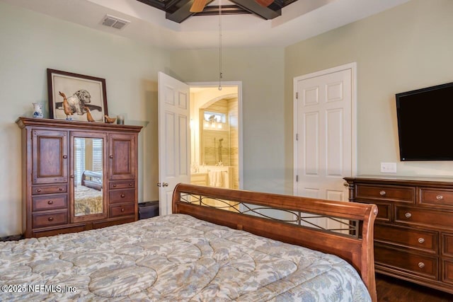 bedroom with ceiling fan, connected bathroom, and dark hardwood / wood-style floors