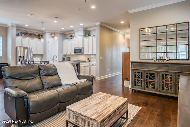 living room featuring ornamental molding, dark hardwood / wood-style floors, and sink