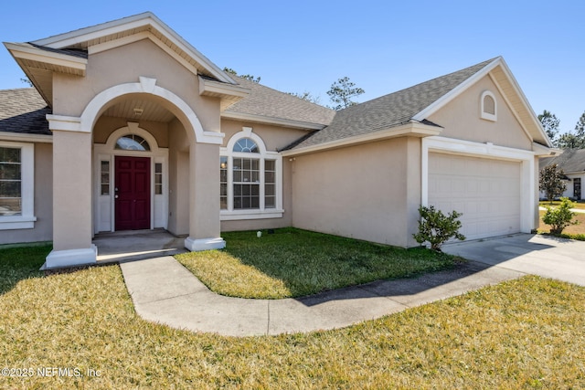 ranch-style house with a garage and a front yard