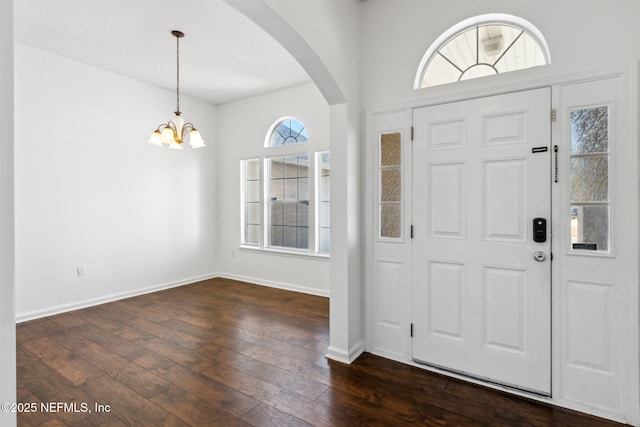 entryway with dark hardwood / wood-style floors and a chandelier