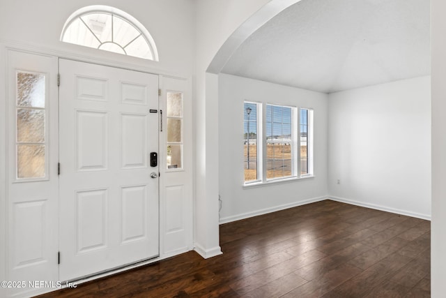 entrance foyer with dark wood-type flooring and lofted ceiling