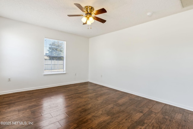 spare room with ceiling fan, a textured ceiling, and dark hardwood / wood-style flooring