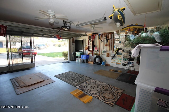 garage featuring a garage door opener and ceiling fan