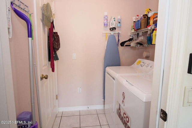 clothes washing area featuring light tile patterned floors and independent washer and dryer