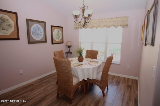 dining room featuring an inviting chandelier and dark hardwood / wood-style floors