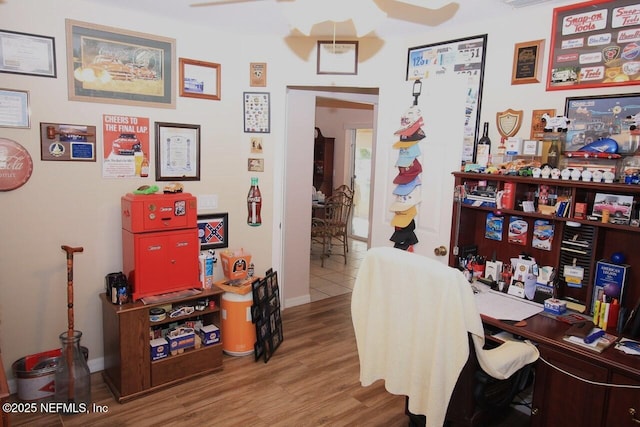 home office with hardwood / wood-style floors and ceiling fan