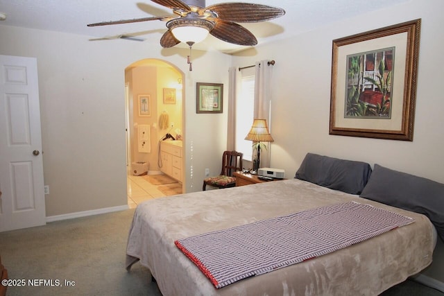 carpeted bedroom with ceiling fan and ensuite bathroom