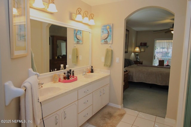 bathroom with tile patterned flooring, vanity, and ceiling fan