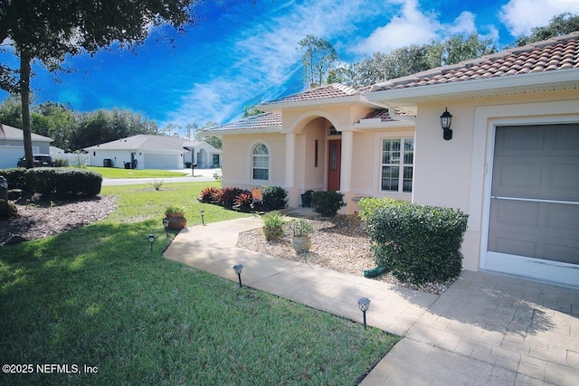 view of front of home featuring a garage and a front lawn