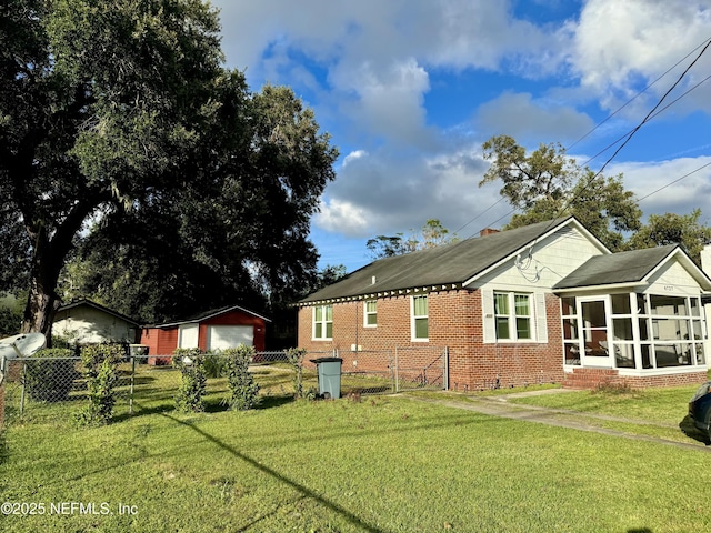 view of home's exterior featuring a yard and a sunroom