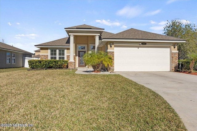 view of front of house with a garage and a front lawn