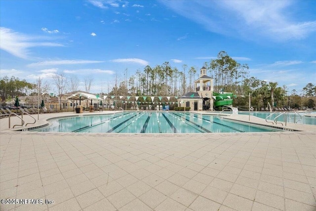 view of pool with a patio area and a water slide