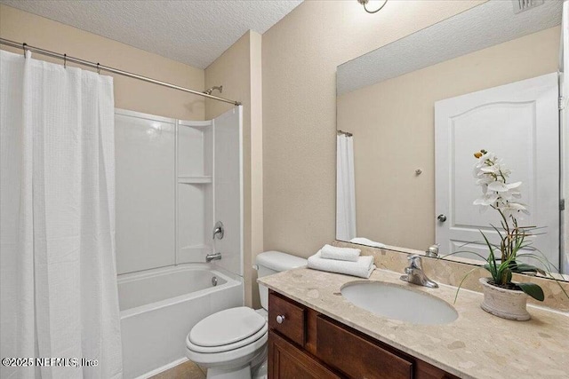 full bathroom with shower / tub combo with curtain, vanity, toilet, and a textured ceiling