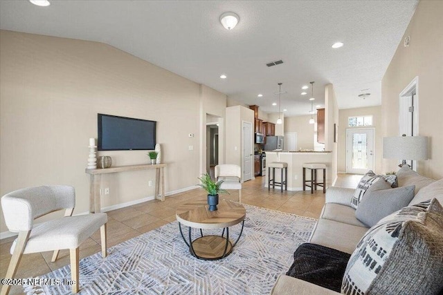 tiled living room featuring lofted ceiling and a textured ceiling