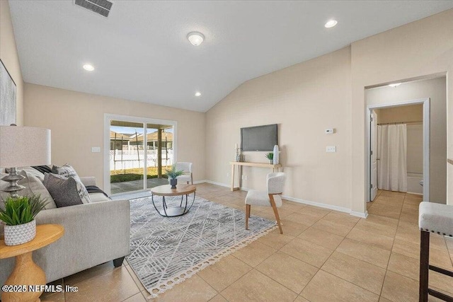 tiled living room featuring vaulted ceiling