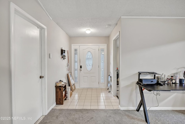 carpeted foyer featuring a textured ceiling