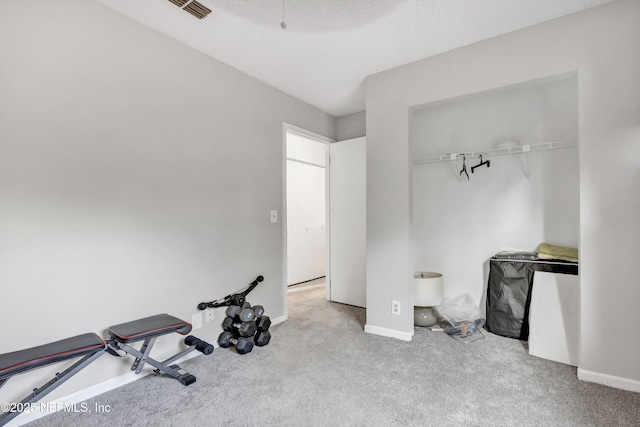 interior space with light colored carpet and a textured ceiling