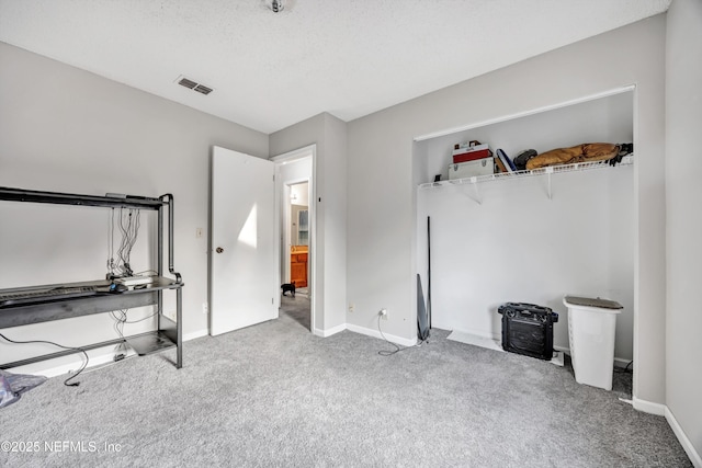 unfurnished bedroom featuring carpet floors and a textured ceiling