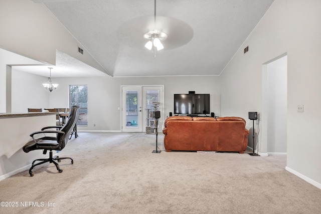 office space featuring vaulted ceiling, carpet, ceiling fan with notable chandelier, and a textured ceiling