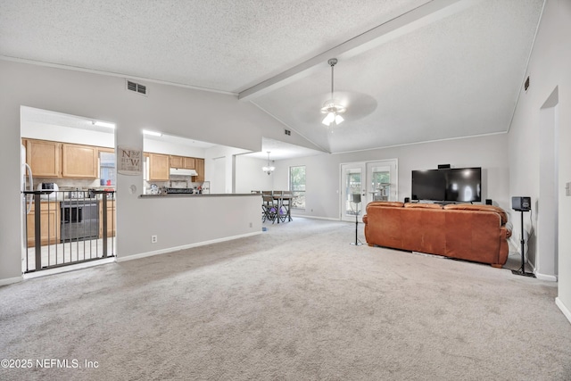 living room with ceiling fan with notable chandelier, high vaulted ceiling, beamed ceiling, light colored carpet, and a textured ceiling