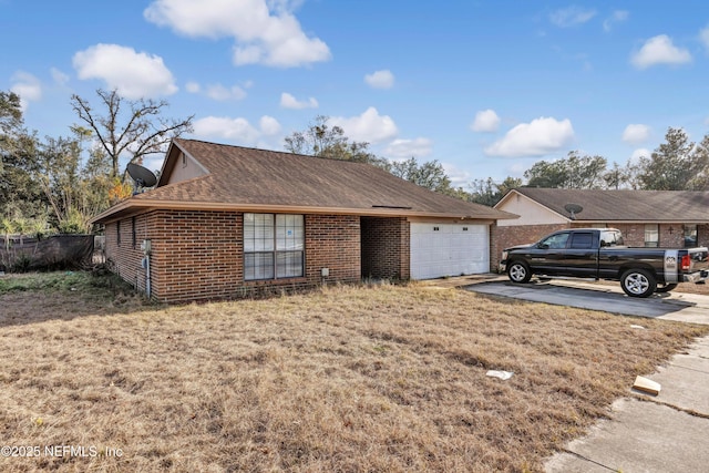 single story home featuring a garage and a front lawn