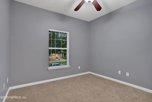 carpeted empty room with ceiling fan and a textured ceiling