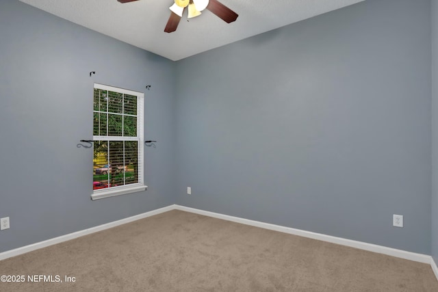 empty room with ceiling fan and carpet flooring