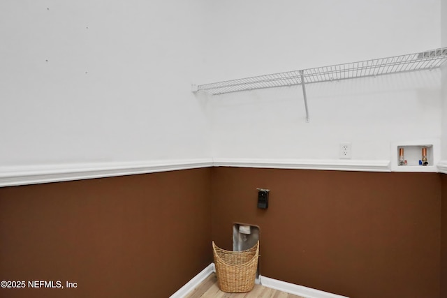 laundry area with light hardwood / wood-style floors, hookup for a washing machine, and electric dryer hookup