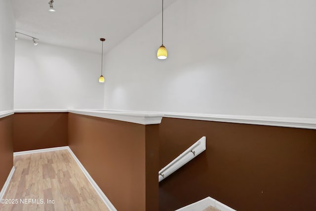 interior space with wood-type flooring and rail lighting