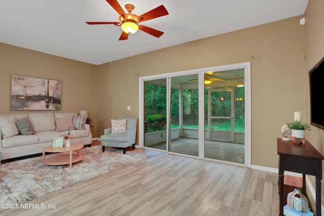 living room featuring light hardwood / wood-style flooring and ceiling fan