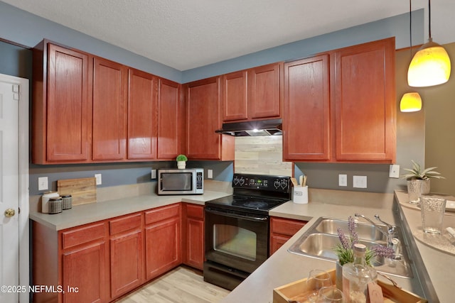 kitchen with hanging light fixtures, black electric range, sink, and a textured ceiling