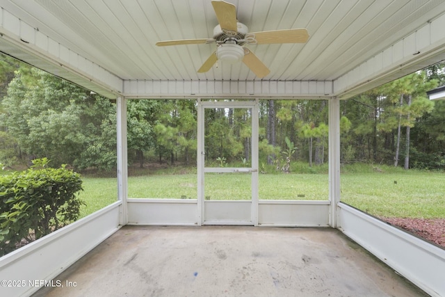 unfurnished sunroom with wood ceiling and ceiling fan