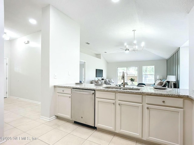 kitchen with light stone counters, sink, vaulted ceiling, and stainless steel dishwasher