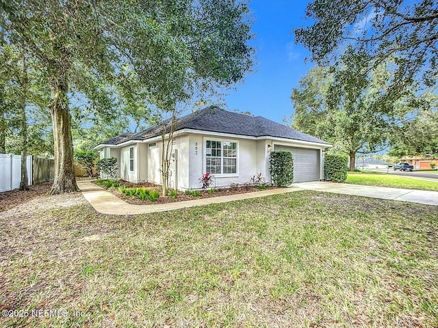 single story home featuring a garage and a front lawn