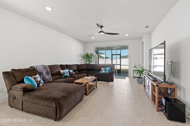 living room featuring ceiling fan and light wood-type flooring