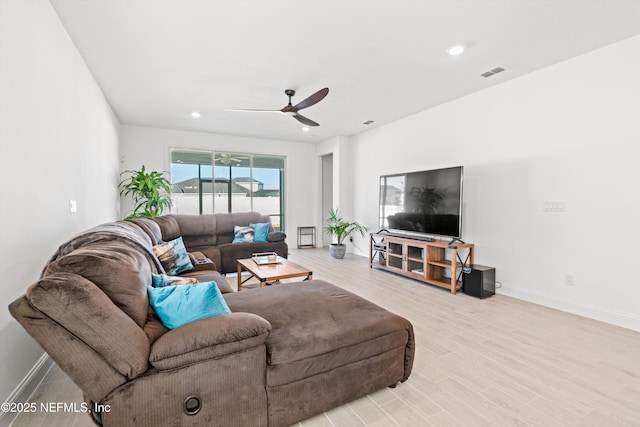 living room with ceiling fan and light hardwood / wood-style floors