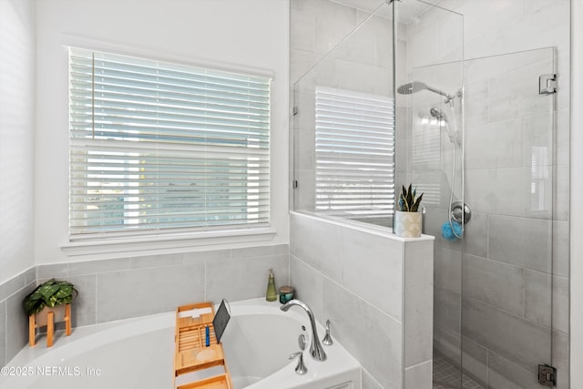 bathroom featuring independent shower and bath