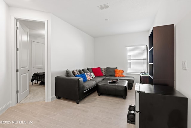 living room with light hardwood / wood-style flooring