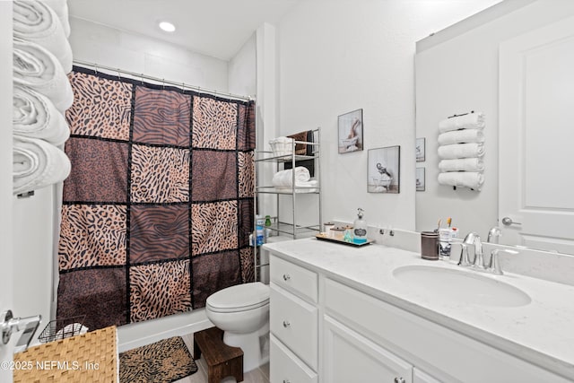 bathroom featuring vanity, toilet, and curtained shower