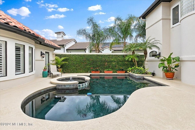 view of pool featuring an in ground hot tub and a patio area