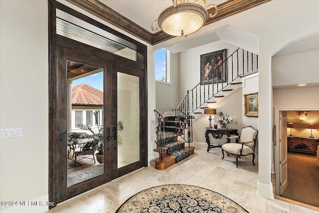 foyer entrance with french doors and crown molding