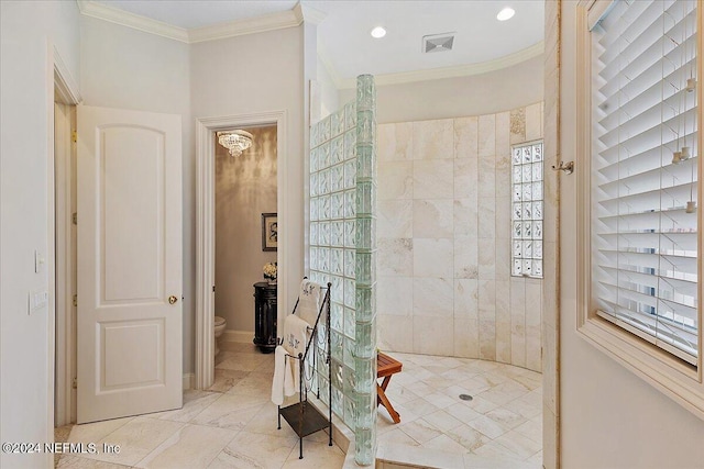 bathroom featuring ornamental molding and toilet