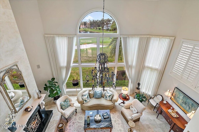 living room featuring a towering ceiling and a notable chandelier