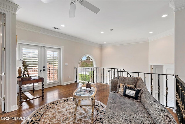 living area featuring crown molding, dark hardwood / wood-style floors, ceiling fan, and french doors