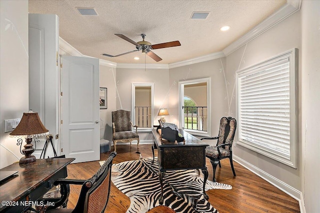 office space with crown molding, ceiling fan, hardwood / wood-style floors, and a textured ceiling