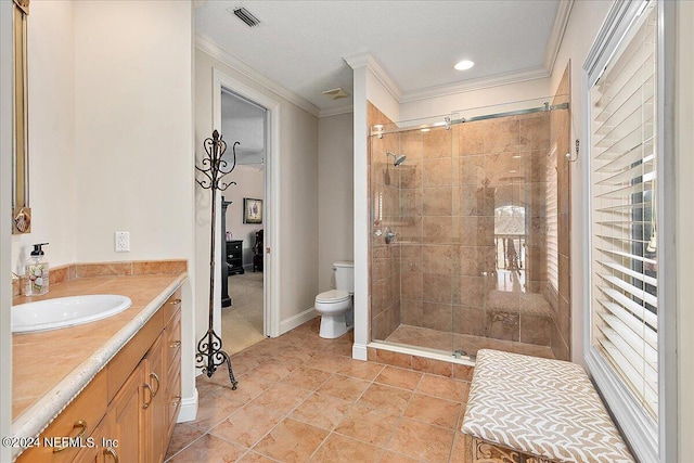 bathroom with ornamental molding, a tile shower, vanity, and toilet